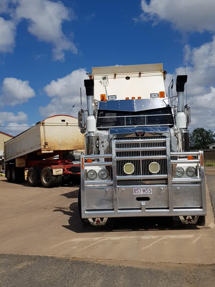 Ashtina Western Star prime mover with a side tipper trailer parked under a blue sky